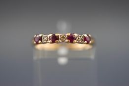 A yellow gold ring set with four rubies and five diamonds. Hallmarked 9ct gold, London. Size: M. 1.