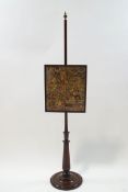 A 19th century mahogany firescreen with embroidered panel depicting figures and animals in the