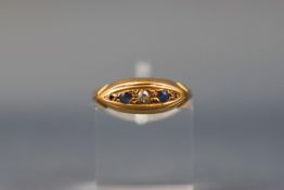 A yellow gold half hoop ring set with two diamonds and two sapphires.