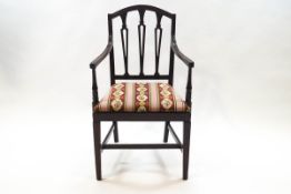 A pair of Sheraton style mahogany elbow chairs,