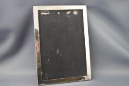 A rectangular silver photograph frame, lacking glass and easel back, Birmingham 1949,