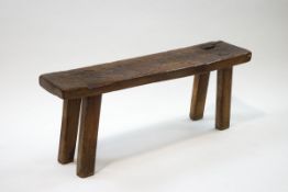 A rustic wooden bench with plank top,