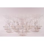 A suite of sixteen 19th century wine glasses, the bowls engraved with flowers and foliage,