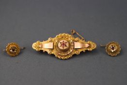 A yellow gold bar brooch of abstract filigree design set with single ruby (all others missing)