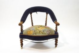 A Victorian walnut nursing chair with tapestry seat,