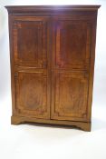 A 19th century mahogany double wardrobe with geometric moulding and crossbanding,