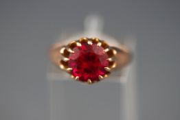 An early 20th century rose gold and synthetic ruby single stone ring, stamped 9ct', size Q, 3.