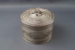 A 19th century Indian white metal cylindrical box and cover,