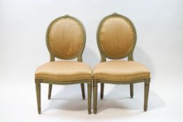 A pair of French style painted salon chairs with oval backs,