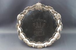 A silver salver with cast shell and scroll border, engraved "Liverpool Polo presented by J.R.