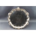 A silver salver with cast shell and scroll border, engraved "Liverpool Polo presented by J.R.