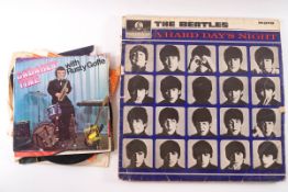 Four Beatles LP records: Beatles for Sale, Please Please Me, A Hard Day's Night, Revolver,