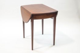 An Edwardian mahogany Pembroke table with stringing and single drawer on square tapering legs,