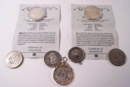 Three silver US dollars and further dollars