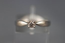 A platinum single stone diamond ring. White shank. Hallmarked Platinum, Birmingham. Size: N 3.