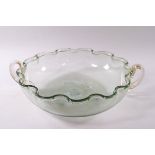 A Venetian green and gold flecked glass bowl with two handles and crimped rim,