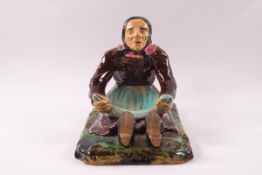 A Victorian Majolica earthenware soap dish modelled as an old woman sitting with her apron