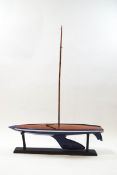 An early 20th century pond yacht with painted blue and white striped hull, no sails, 104cm long,