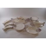 A West German earthenware fish service, comprising one 12" serving dish, six curved dishes,