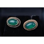 A yellow gold pair of 9ct gold stud earrings each set with green chalcedony cabochon.