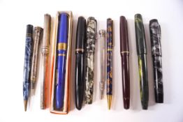 A collection of fountain pens, other pens and pencils,