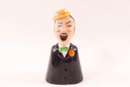 A unusual Carlton Ware candle snuffer in the form of a winking gentleman,
