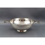 A Scottish silver quaiche with two flat handles and a plain bracket foot,