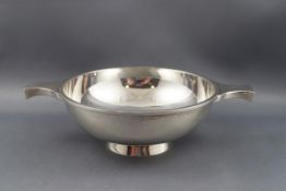 A Scottish silver quaiche with two flat handles and a plain bracket foot,