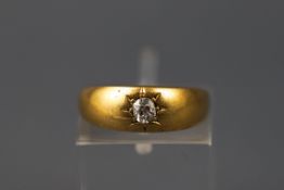 A yellow gold single stone gypsy ring set with an old brilliant cut diamond. Yellow shank.