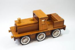 A handmade cherrywood push along toy train,