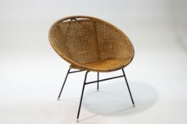 A mid-20th century cane chair with metal legs,