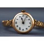A yellow gold ladies wristwatch. Unbranded. White ceramic numerical dial. Blued hands.