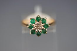 An 9ct gold, emerald and diamond cluster ring,