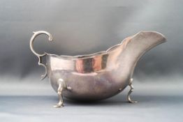 A silver sauce boat, with flying double C scroll handle,