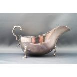 A silver sauce boat, with flying double C scroll handle,