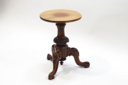 A Victorian rosewood piano stool with replacement seat,