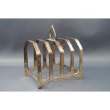 A silver four division toast rack, with pierced knop, 8.5cm wide, Birmingham 1933, 2.