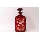 A Victorian Bohemian style square red glass decanter and stopper, wheel engraved foliate,