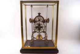 A skeleton clock with eight day fusee movement and grasshopper escape, cased and on a stand,