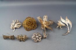 A selection of brooches of intricate filigree wire design.