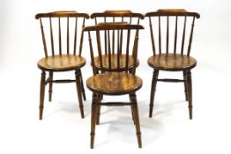 A set of four Victorian beech stick back dining chairs on turned tapering legs with H-stretchers