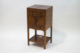 A George III mahogany washstand, two dummy drawers over a cupboard and single drawer and undershelf,