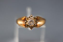 A yellow gold cluster dress ring. Set with nine round cut cubic zirconia.