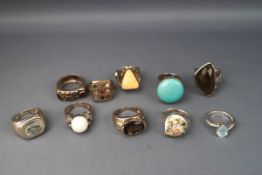 A selection of ten dress rings to include quartz, turquoise, honey amber and topaz stones.