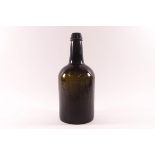 A 19th century glass wine bottle, indistinct raised lettering to base,