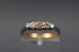 A yellow gold and Platinum half hoop ring set with five graduated old brilliant cut diamonds.
