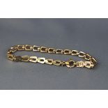 A yellow and white gold linked bracelet, trigger clasp. hallmarked 9ct gold, London. 7.