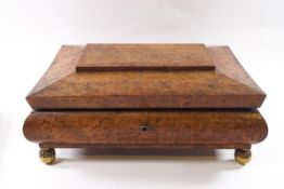 A Victorian burr walnut work box of sarcophagus form with brass ball feet,