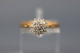 A yellow gold cluster ring set with nineteen single cut diamonds. Yellow gold shank.