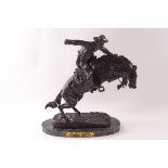 A 20th century bronze of 'Bronco Buster' by Frederic Remington,